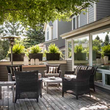 view of a patio with furniture in a shaded spot on a sunny day