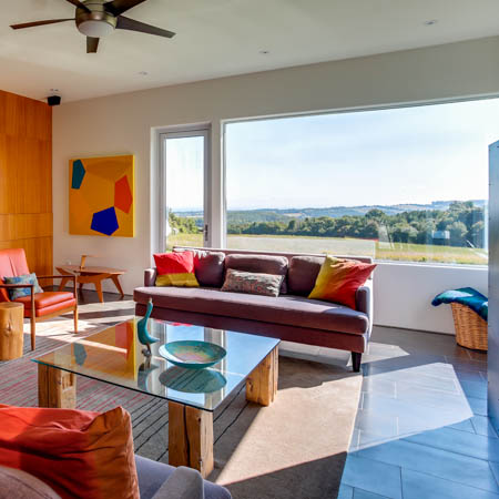 a very colorful living room interior on a bright day in the summer