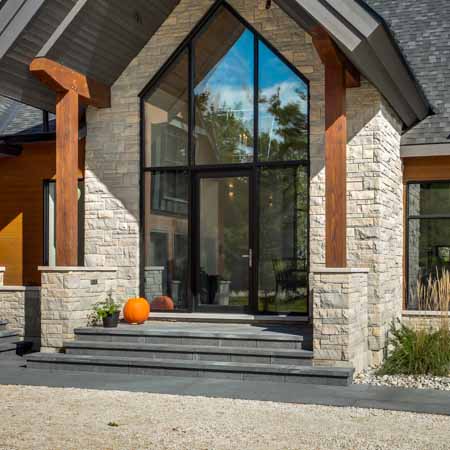 Custom Chalet front entrance view in sunny summer day