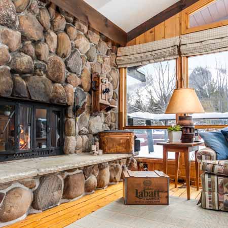 Stone fire place in a rustic chalet at Georgian Peaks Ski Club for real estate client