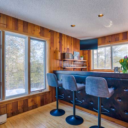 A custom bar in a home with an updated retro feel