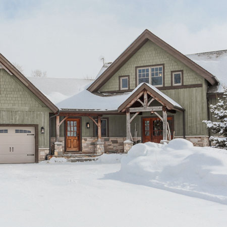 Exterior view of a large home in winter for real estate