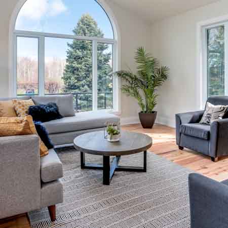 Large window lighting up a bright living room.