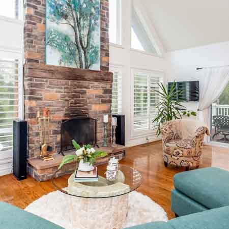 Inviting living room with large fireplace and high ceilings