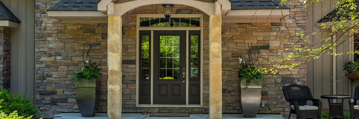 a beautiful stone entrance to a home for real estate photography
