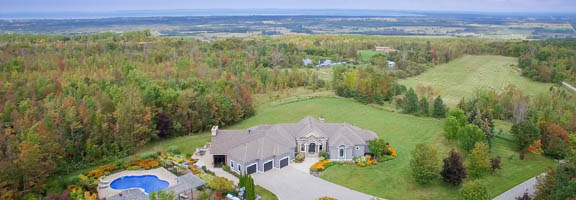 an aerial view of a large estate with views to distance for aerial real estate photography