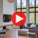 living room with a play button for a real estate video tour